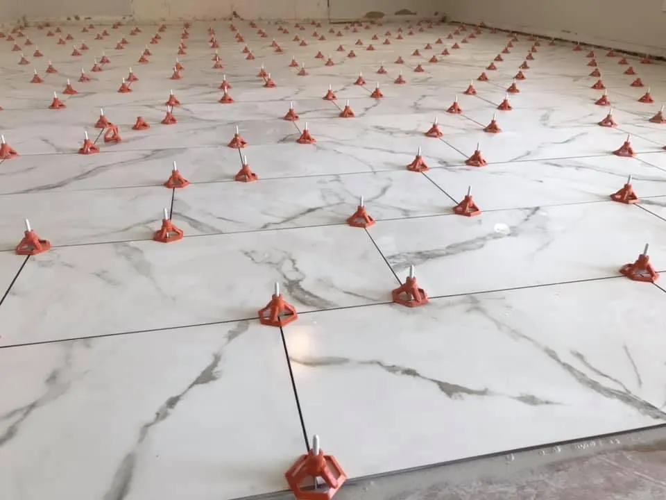 Completed porcelain tile floor across an open interior